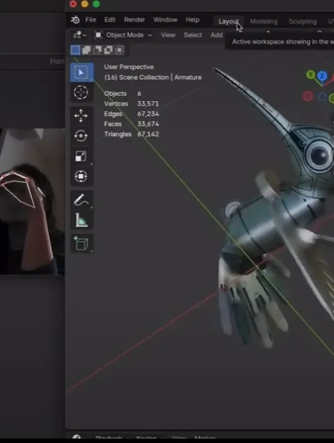 Un modelo de colibrí robótico en Blender. Una ventana pequeña muestra una mano con líneas de seguimiento.